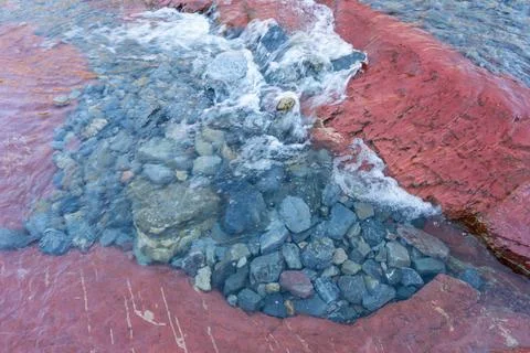 River flowing through red rock formations creates natural beauty spots. Stock Photos