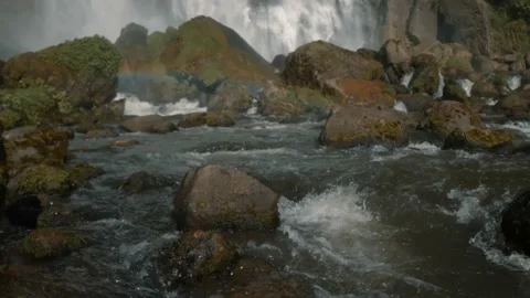 River flowing through rocks at base of waterfall Stock Footage 140611996