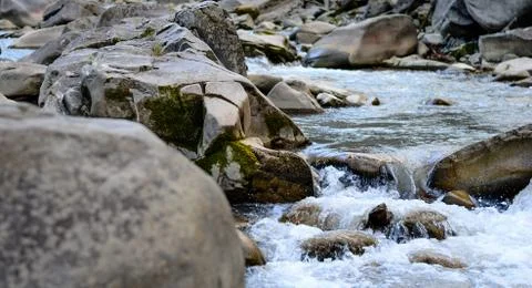 River flowing through rocks during summer . Montain river . . Stock Photos