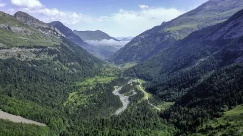 River Flowing Through Scenic Alpine Landscape Stock Photos