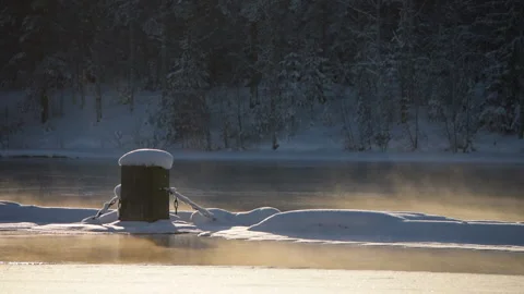 River flowing through snow and frost covered winter landscape, freezing weather Stock Footage 148507807