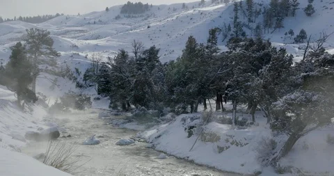 River flowing through the snow covered mountain in Yellowstone National Park Stock Footage 93375998