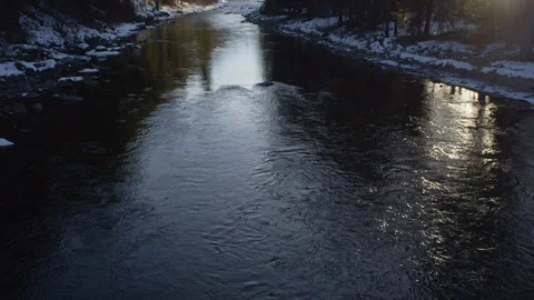 River flowing through snowy mountain forest Stock Footage 116739383