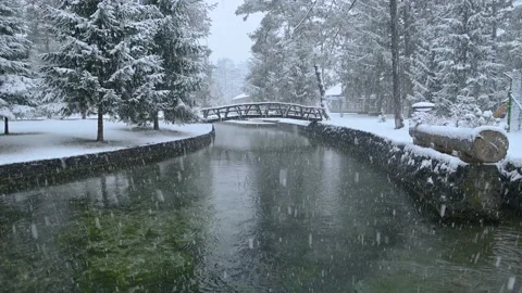 River flowing through stone canal with a wooden bridge Stock Footage 145868261