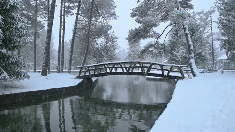 River flowing through stone canal with a wooden bridge Stock Footage 145868417