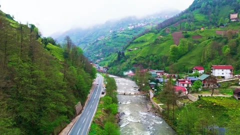 A river flowing through a valley surrounded by mountains Stock Footage 272791611