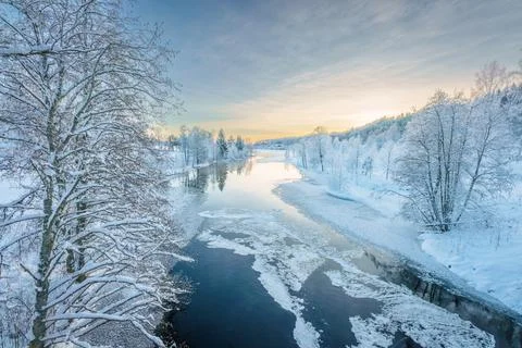 River flowing through the winter forest in Sweden Stock Photos