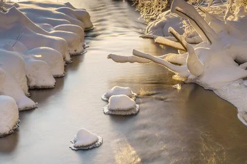 River flowing through the winter forest in Sweden Stock Photos