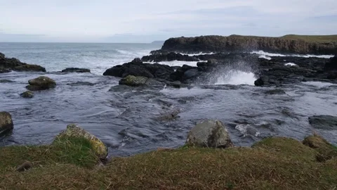 River flowing towards Atlantic Ocean at Dunseverick Falls Vídeos de archivo 303451579