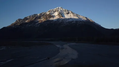 River flowing towards the snow clad mountain Stock Footage 104560655