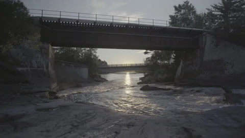 River Flowing Under Bridge Stock Footage
