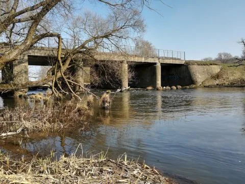 River flowing under the bridge. Stock Photos