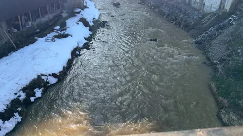 River flowing under bridge in winter Stock Footage 309481372