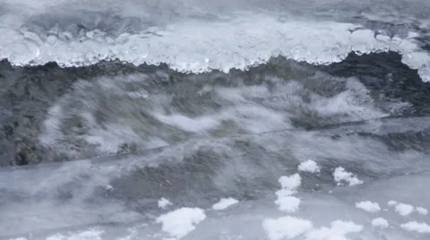 River flowing under a hole in the ice Stock Footage 37216645