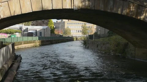 A River Flowing Under A Stone-built Road Bridge Stock Footage 163366431