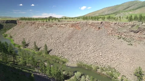River flows along a deeply incised rocky valley - Slope Failure and Mass Wasting Vídeos de archivo 339704831
