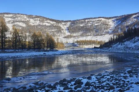 The river flows among the mountains in winter Stock Photos
