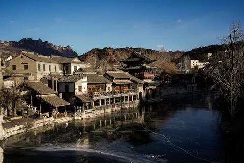 River flows between hills and houses in Gubei water town, Beijing, China - D Foto stock