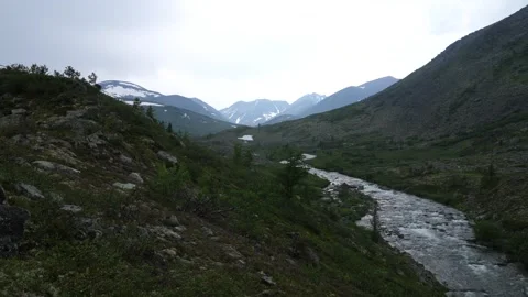 River flows between the mountains Stock Footage 281654759