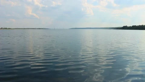 The river flows calmly, there are clouds in the sky Stock Footage 158012279