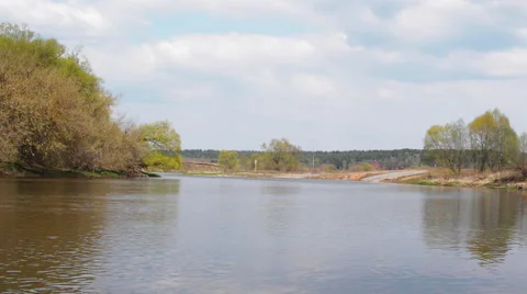River Flows in Early Spring. the Clouds High Overhead. Fishermen Catch Fish, Stock Footage 62777611