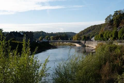 River flows gently beneath a stone bridge Photos
