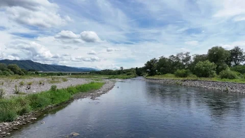 River flows gently through green landscape Stockbeeldmateriaal 343256722