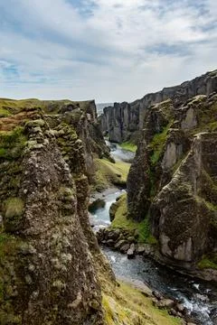 A river flows gracefully through a scenic canyon in the south of Iceland Stock Photos