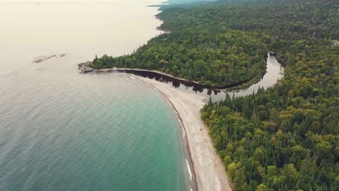 A RIVER FLOWS INTO LAKE SUPERIOR Stock Footage 227409836
