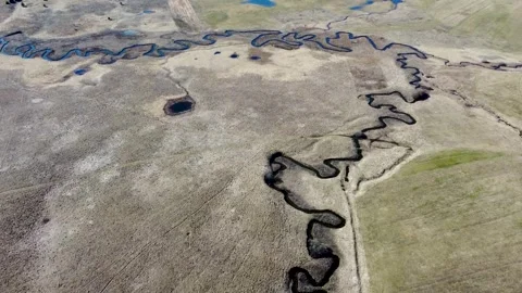 The river flows meanderingly through the field. A winding river Stock Footage 304639835