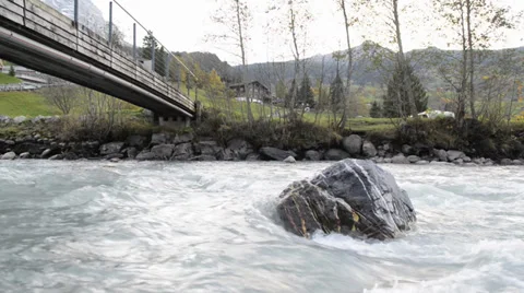 River flows over rocks in this beautiful scene in the swiss Alps Stock Footage 33782581