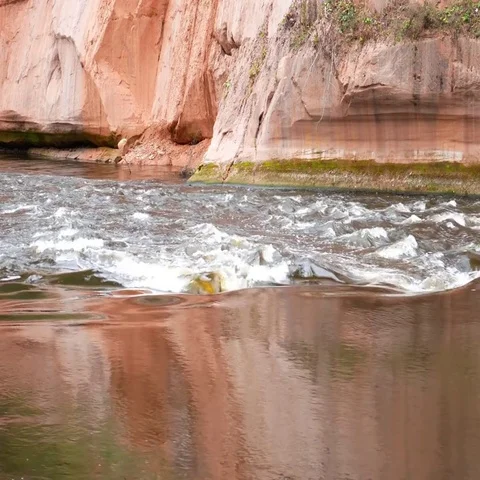 A river flows over rocks in this beautiful scene. Stock Footage 69488367