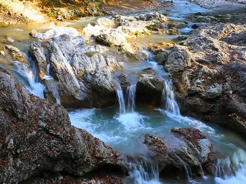 A river flows over rocks in this beautiful scene in the  mountains in autumn Stock Footage 80345218