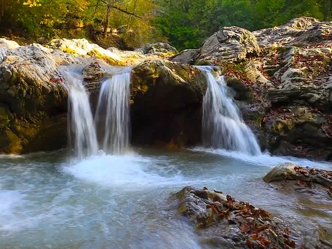 A river flows over rocks in this beautiful scene in the  mountains. Cinemagraph Stock Footage 80345353