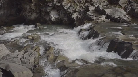 A river flows over rocks in this beautiful scene Stock Footage 97822633