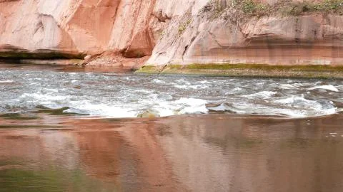 A river flows over rocks in this beautiful scene. Stock Photos