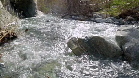 River Flows Over Rocks Downstream Stock Footage 102065472