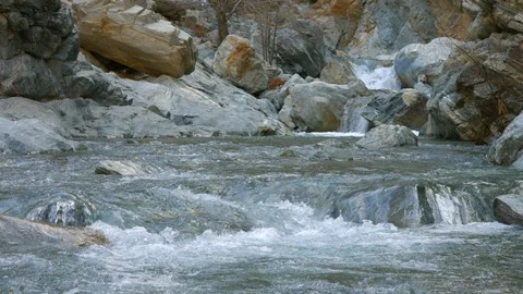 River Flows Over Rocks in Mountains Video stock 102239399