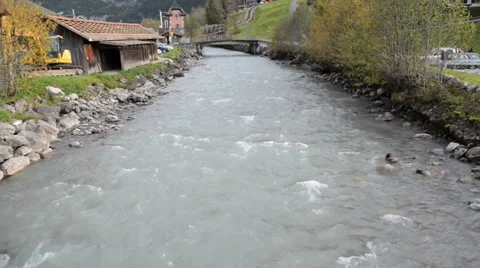 A river flows over rocks in the swiss Alps mountains in autumn Stock Footage 32315405