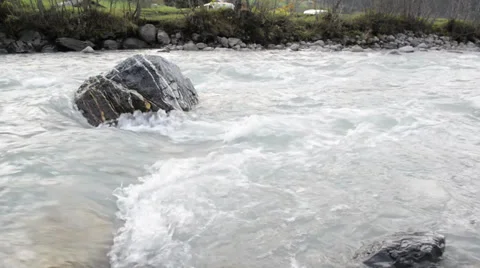 A river flows over rocks in the swiss Alps mountains in autumn Stock Footage 32316139