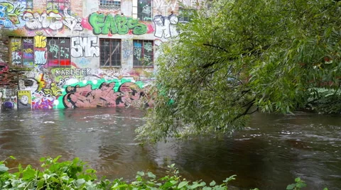 River Flows Past Graffiti Painted Building in Oslo Norway Stock Footage 63656046