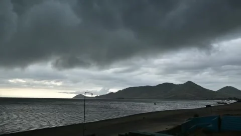 The River Flows Slowly, Mountains Stand Tall, Dark Clouds Cover the Sky Stock Footage 306715280