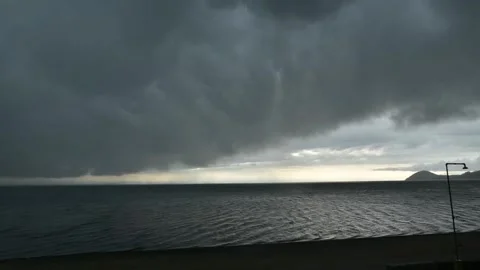 The River Flows Slowly, Mountains Stand Tall, Dark Clouds Cover the Sky Stock Footage 306715281