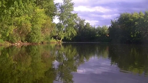 The river flows slowly - the sky is reflected in the river Stock Footage 78642470