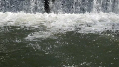The river flows swiftly from the dam Stock Footage 280391213