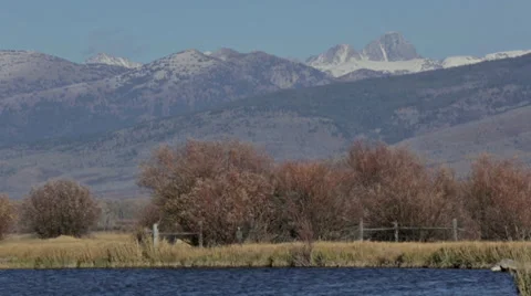 A river flows with the Teton mountain range in the background Stock Footage 36319192