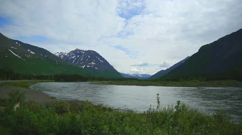 River Flows Through Grassy Mountain Valley Stock Footage 37435205