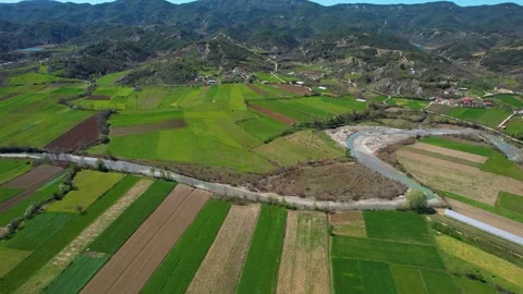 River Flows Through Green Parcels in a Village Landscape: Cultivated Land Stock Footage 271561138