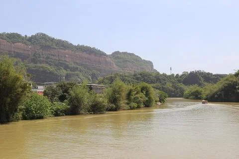 A river flows through the jungle, with cliffs on both sides and green veget.. Stock Photos