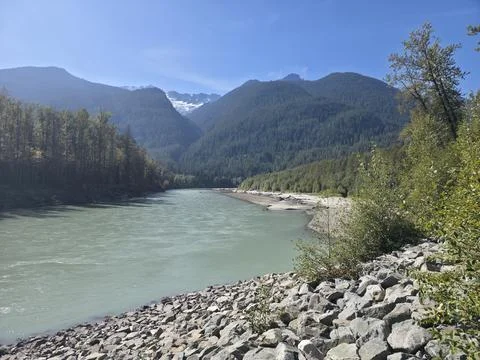River Flows Through the Mountain Valley 스톡 사진